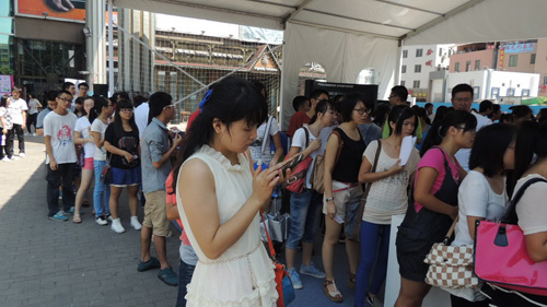 互動游戲區(qū)人頭攢動，大家熱情參與，長隊(duì)一直排到場館外